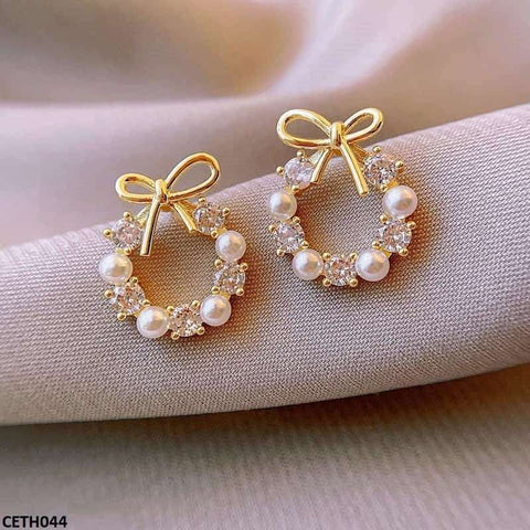 Enhance your style with CETH044 SGC Pearl Bow Tops Pair. These elegant fashion accessories from TJ Wholesale Pakistan are designed to make a statement. Made with high-quality artificial materials, these fashion jewelry pieces are a must-have for any fashionista.